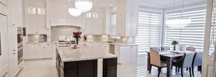 Spacious kitchen with white cabinets and central island.