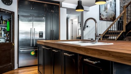 Designer Kitchen with central island, modern appliances and elegant lighting.