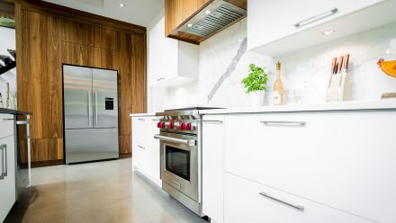 Refined white Kitchen, white quartz worktop and stainless steel appliances.