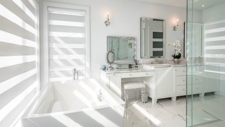 Under-sink storage unit in an elegant white and grey bathroom.