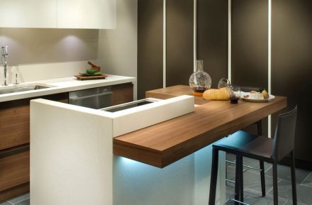 Kitchen cabinet with grey doors and brushed steel handles. Modern and elegant design.