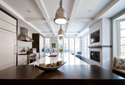 Old renovated kitchen, white cabinets and sand-colored countertops, rustic chic style.