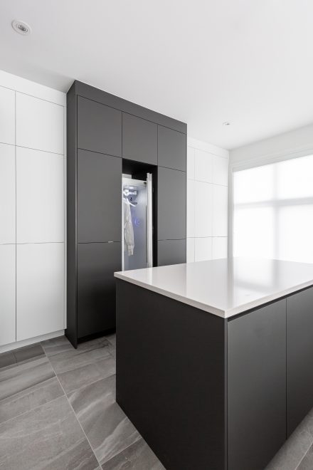High-end laundry room with functional storage.